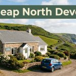 A coastal guesthouse beside green hills with a car and distant sea.