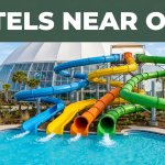 Colorful water slides and a splash pool appear beneath a Hotels Near OWA banner.