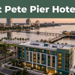 Modern hotel with the St. Pete Pier behind it at sunset.