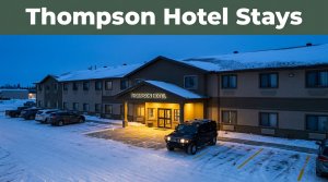 Snow surrounds a lit Manitoba hotel entrance and parked SUV.