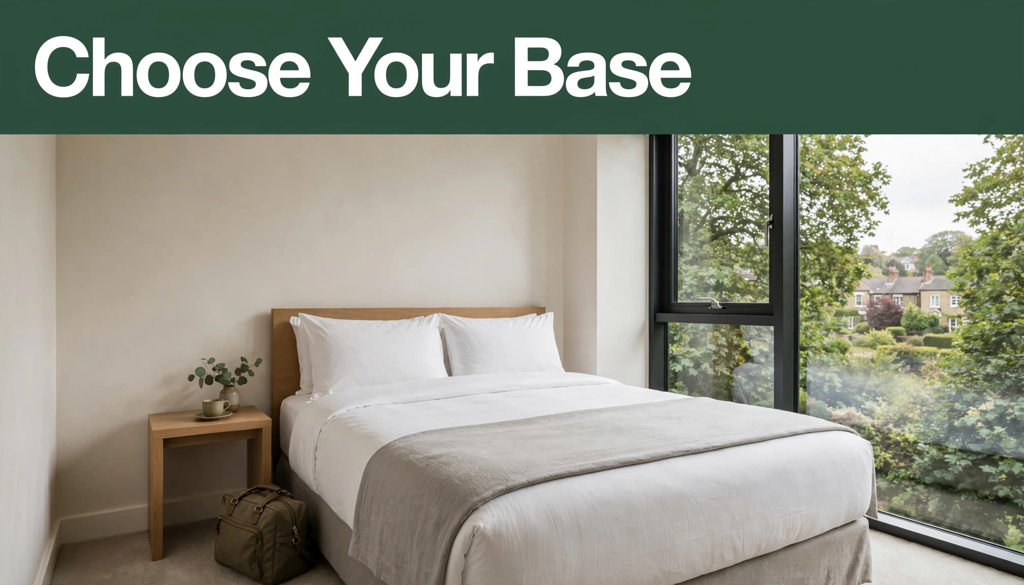 A tidy hotel room with a bed, travel bag, and leafy view through the window.