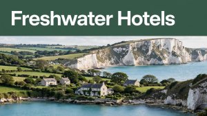 Freshwater Bay cliffs, turquoise sea, cottages, and a coastal guesthouse beneath a green headline band.