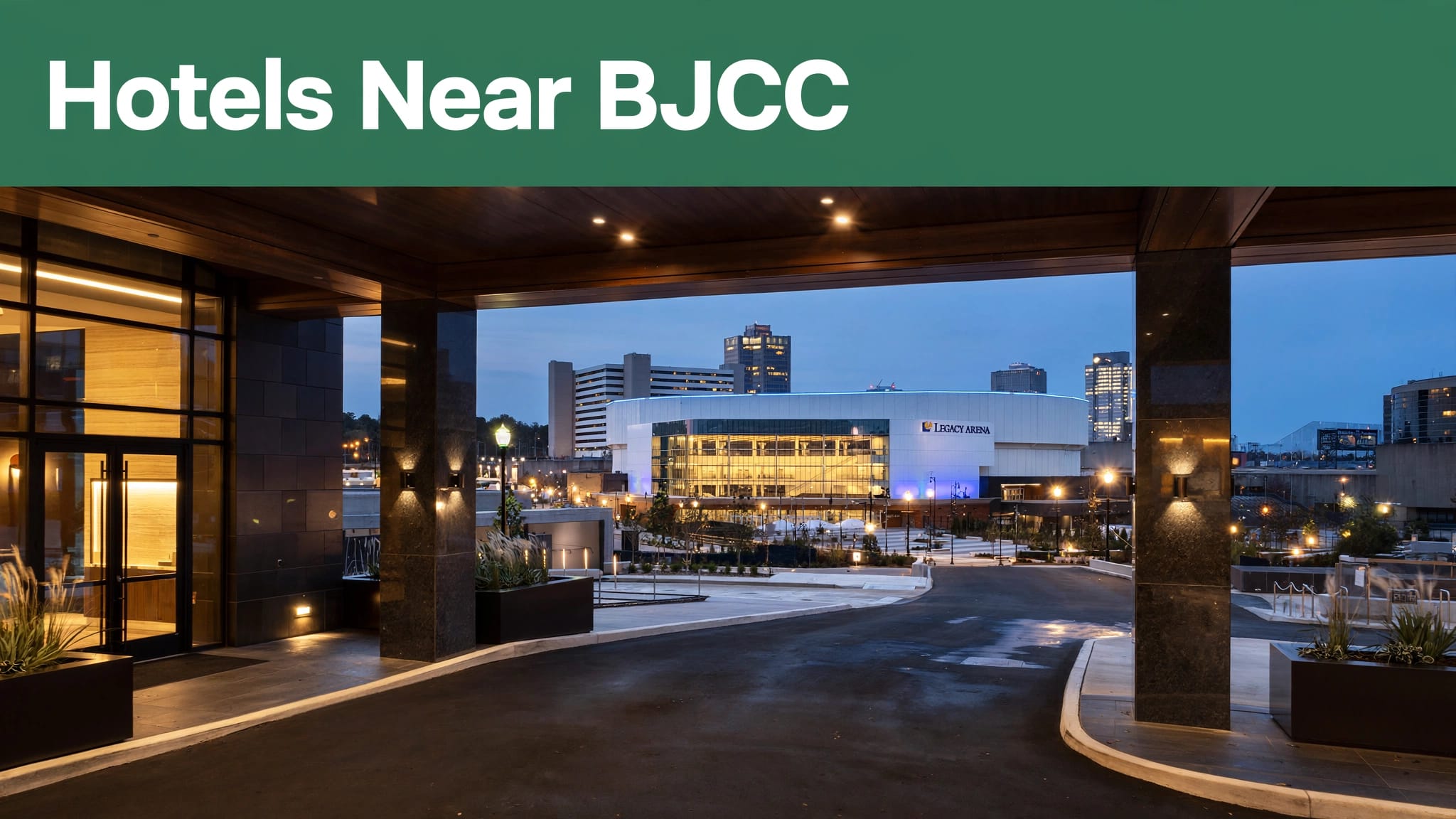 BJCC Legacy Arena glowing downtown Birmingham at blue hour, viewed from a hotel entrance.