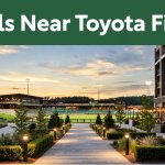 Toyota Field illuminated at sunset with nearby hotels and restaurants.