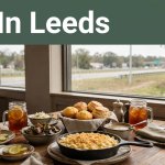 Southern food on a restaurant table with Parkway Drive visible through the window.