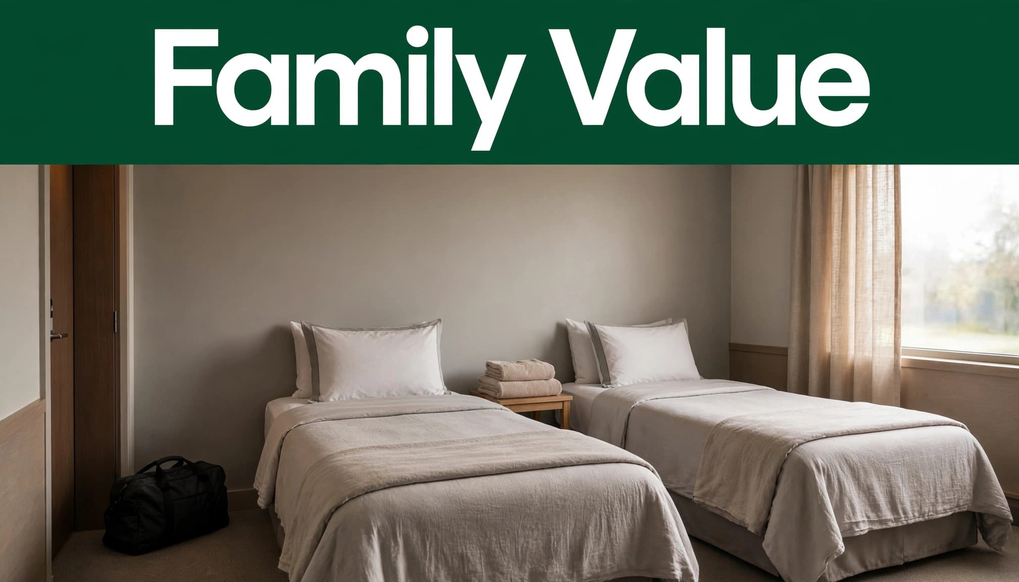 A clean hotel room with two beds, folded towels, and a travel bag by the entry.