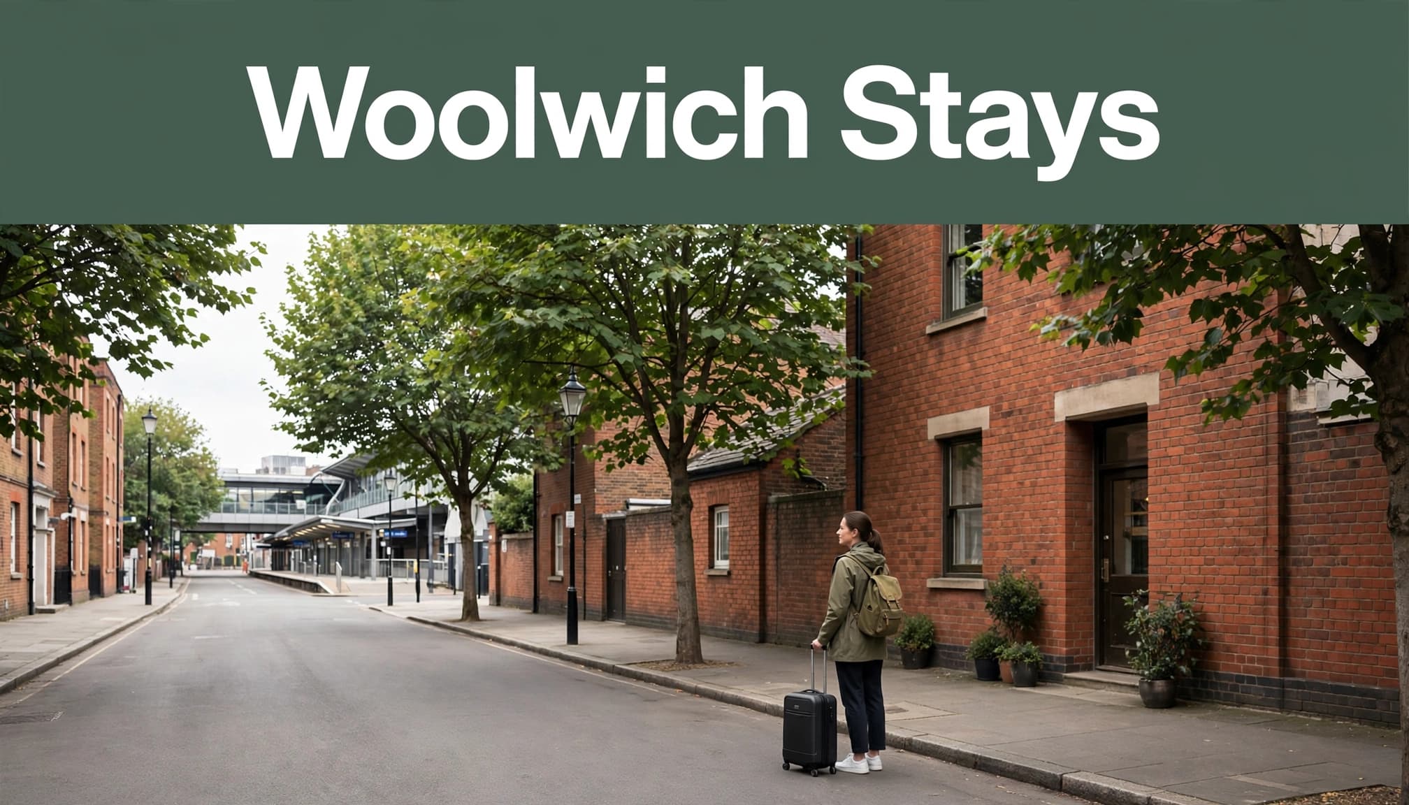 A traveler with a small suitcase stands outside a modest hotel in Woolwich.